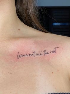 a woman with a tattoo saying leave out all the rest on her upper back shoulder