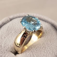 "This beautiful genuine Blue Zircon ring is set in a very heavy 14kt White Gold 6 prong center mount. The Base of the ring is oversized 14kt solid Yellow Gold shank, with a unique, round shape that tapers gently towards the top & Bottom. Last detail but not the least is the 4pcs natural blue diamonds button-set straight into the shank. This one-of-a-kind attention getter is perfect for the Mrs. Gotrocks in your heart! Net weight (10.2g) **Blue Zircon is the official, and original December Bi Blue Aquamarine Solitaire Ring, Blue Topaz Ring With Prong Setting In 14k Gold, 14k Gold Blue Sapphire Ring With Center Stone, Blue Birthstone Ring With Center Stone In 14k Gold, 14k Gold Topaz Ring With Sapphire Center Stone, Sapphire Topaz Ring With Center Stone In 14k Gold, 14k Gold Sapphire Topaz Ring With Center Stone, Blue Topaz Rings With Brilliant Cut, Blue Solitaire Diamond Ring In 14k Gold