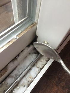 the corner of a window sill that has been gutted with ice and snow