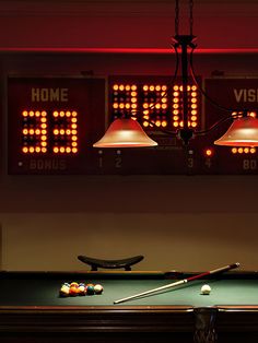 a pool table that has some lights on it