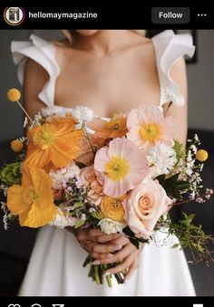 a woman holding a bouquet of flowers in her hands