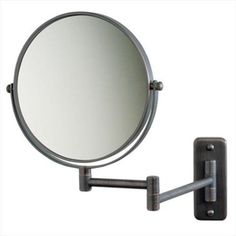 a wall mounted magnifying mirror on a white background