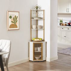 a white and gold shelving unit in the corner of a dining room with chairs