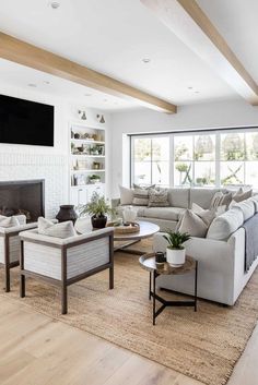 a living room filled with furniture and a flat screen tv mounted on the wall above a fireplace