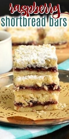 raspberry shortbread bars stacked on top of each other with coffee in the background