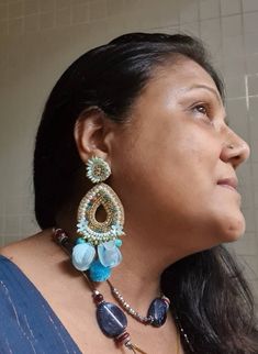 "Bohemian handmade statement turquoise blue embellished large earrings. These beautiful turquoise earrings are hand crafted beautifully using various material like fabric, glass, chatton,pompoms etc. An ideal summer party earrings The earrings measure about approx. 3.80\" long and 2.20\" wide. At Carnation jewellery, each piece is handmade and handcrafted in India, there may be a slight imperfection due to the nature of work but we try our best to make them look perfect. * The products are made Bohemian Teardrop Chandelier Earrings For Party, Blue Drop Danglers For Festive Occasions, Bohemian Teardrop Earrings For Parties, Handmade Blue Danglers For Wedding, Bohemian Teardrop Dangle Earrings For Party, Blue Chandbali Chandelier Earrings For Party, Handmade Blue Chandelier Earrings For Festive Occasion, Blue Bridal Earrings With Latkans, Bohemian Style Party Bridal Earrings