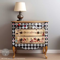 an old dresser has been decorated with many different designs on it and is next to a lamp