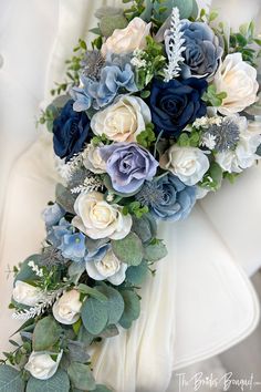 a bridal bouquet with blue and white flowers