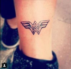 a small wonder woman tattoo on the ankle