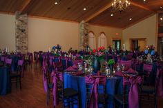 the tables are set with purple and blue linens