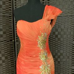 Gorgeous Orange Shimmering Color. You Will Definitely Get Noticed In This Beautiful Gown. Elegant Orange Gown For Formal Occasions, Elegant Orange Formal Gown, Embellished Orange Evening Dresses, Elegant Orange Gown With Fitted Bodice, Elegant Fitted Orange Gown, Elegant Orange Evening Dress, Glamorous Orange Gala Dress, Glamorous Orange Dress For Gala, Orange One-shoulder Evening Dress