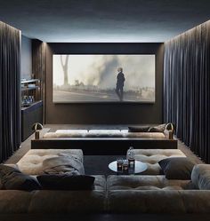 a living room with two couches and a large screen