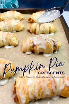 pumpkin pie crescents with icing being drizzled over them on a baking sheet