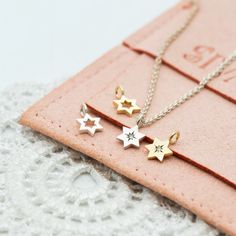 Tiny Delicate Star of David gold charms gold for necklace or earrings, a symbol of Jewish faith and heritage, a beautiful piece of Israeli Jewelry. Three styles to choose from: Open star Full star Diamond star TINY STAR OF DAVID CHARM ✧ DETAILS: ✦ 14K white/yellow/rose gold. Please select your preferred choice from the drop-down menu, when ordering. ✦ The star charm measures 5 mm (0.20") in diameter. ✦ Also available with a chain necklace :  ✧ 14 inches necklace  ✧ 16 inches chain necklace  ✧ 18 Dainty Gold Star Charm, Gold Star-shaped Jewelry With Charms, Yellow Gold Star Charm Pendant Necklace, Star-shaped Jewelry With Star Charm As Gift For Her, Sterling Silver Star Charm Necklace In Yellow Gold, Yellow Gold Sterling Silver Star Charm Necklace, Celestial Yellow Gold Charm Necklaces With Star Charm, Star Charm Jewelry Gift For Her, Celestial Yellow Gold Charm Necklace With Star Charm