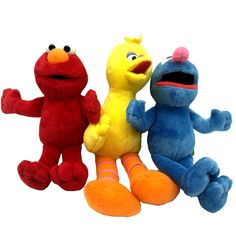 three stuffed animals sitting next to each other in front of a white background with the sesame character