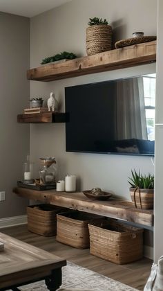 a flat screen tv mounted to the side of a wall next to baskets and plants