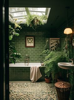 a bath room with a tub a sink and plants