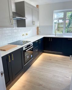 an empty kitchen with blue cabinets and white counter tops