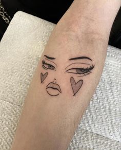 a woman's arm with an evil face tattoo on it