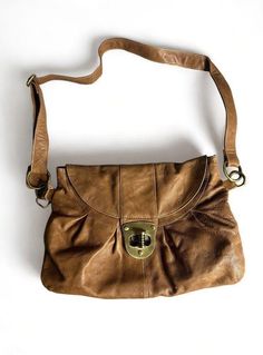 This vintage Aldo women's shoulder handbag is a stylish addition to any wardrobe. Crafted from high-quality leather, this medium-sized bag is perfect for everyday use. The exterior features a beautiful brown color that complements any outfit, making it a versatile accessory. The bag is designed with a shoulder strap for easy carrying and comes in a stylish Aldo brand. It's perfect for women who want a chic and practical accessory. Whether you're running errands or going out for a night on the town, this bag is sure to impress. Please look at the pictures for sone flaws and also inside bag theres a minor stain that can potentially be cleaned but I didnt try. Message me if you have any questions. Medium Sized Bags, Inside Bag, Sling Bags, Handbag Women, Outfit Making, Shoulder Handbag, Hobo Bag, High Quality Leather, Shoulder Handbags