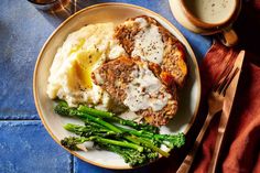 meatloaf, mashed potatoes and broccoli on a plate with two forks