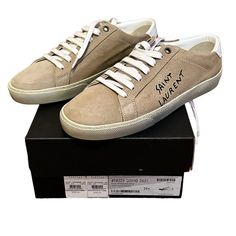 Saint Laurent Authenticated Suede Sneakers, Tan, Size 39.5 Eu, 9.5 Us New With Tags, Box And Dust Bag Included Elevate Your Style With These Impeccable Saint Laurent Sl 06 Low Trainer Logo Sneakers. Crafted In Luxurious Beige Suede, In Pristine New Condition, These Sneakers Are A Must-Have For Any Fashion-Forward Individual. Saint Laurent Suede Soho Low Top Sneakers Color: Desert/Blanc (Tan) Upper: 100% Suede Sole: Rubber Graphic Print Logo Round Toes Lace-Up Closure At Uppers Designer Suede Low-top Sneakers, Designer Low-top Suede Custom Sneakers, Designer Low-top Suede Sneakers, Suede Sneakers With Embroidered Logo And Round Toe, Designer Suede Lace-up Sneakers, Round Logo, Saint Laurent Shoes, Low Top Sneakers, Suede Sneakers