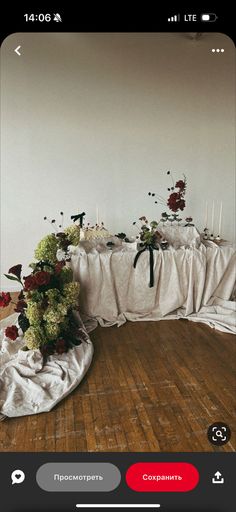 an image of a table with flowers and candles on it in the middle of a room