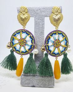 Sicilian cart wheel earrings with yellow agate pendant, green tassels, golden sacred holy heart Italian folklore, Sicily traditional The inspiration for these earrings comes from the colorful wheels of the typical traditional Sicilian carriages. This piece of jewelry composed by an appropriately shaped and painted wooden base, embellished with green cotton tassels and a central agate pendant. Golden tone studs (zinc-alloy, nickel free) are shaped as sacred hearts. Please take a look at this diff Traditional Gold Tassel Festival Earrings, Traditional Gold Tassel Earrings For Festivals, Tassel Earrings As Festival Gifts, Festival Tassel Earrings As Gift, Tassel Earrings For Festivals And Gifts, Gift Tassel Earrings For Festivals, Traditional Green Tassel Earrings, Bohemian Yellow Earrings With Latkans, Yellow Bohemian Earrings With Latkans