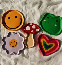 four cookie molds with different designs on them sitting on a tablecloth covered surface