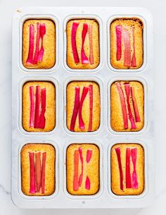 an open muffin tin filled with cupcakes covered in rhubarb