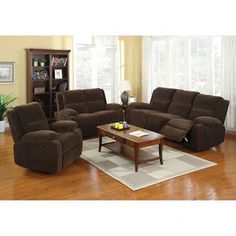 a living room filled with furniture and a coffee table on top of a hard wood floor