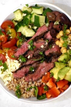 a white bowl filled with meat, rice and veggies