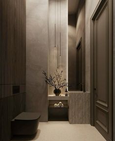 a bathroom with a sink, mirror and vase on the wall in front of it