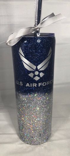 the u s air force tumbler is decorated with silver glitter and a ribbon on top