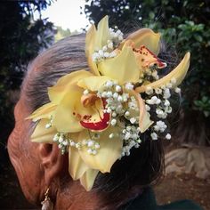 a close up of a person with flowers in their hair