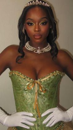 a woman wearing a green corset and pearls