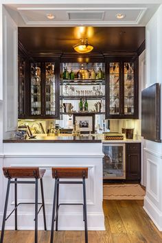 two stools are in front of the bar