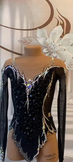 a mannequin wearing a black and white top with sequins on it