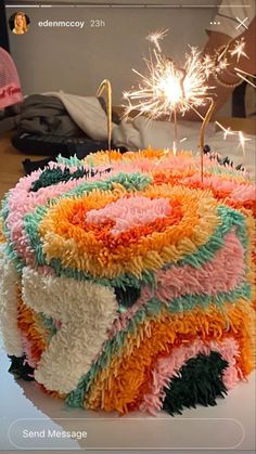 a colorful cake with sparklers on top