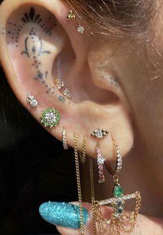 a person with some piercings on their ear and behind the ear is a piece of jewelry