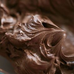 chocolate frosting in a glass bowl with a spoon