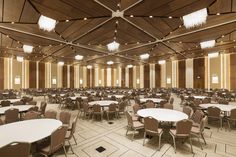 an empty banquet hall with tables and chairs