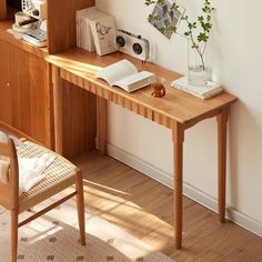 a wooden desk with books and a plant on it