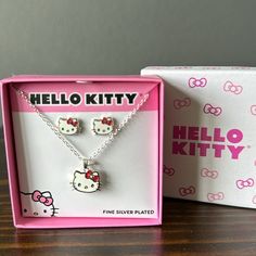 Super Adorable New Hello Kitty Necklace (16") And Matching Earrings. Sized Perfectly For Everyday Wear. Super Cute Red Crystal Detail In Hello Kitty's Bow. Gorgeous Fine Silver Plated. Includes The Gift Box Approx Earring Dimensions: 8.06 Mm L X 11.17 Mm W X 2.00 Mm H, Necklace Dimensions 16.7 Mm L X 13.2 Mm W X 2.2 Mm H Hello Kitty White Necklace For Gift, White Hello Kitty Necklace For Gift, White Hello Kitty Necklace Gift, White Sterling Silver Hello Kitty Jewelry, Cute White Hello Kitty Jewelry, Hello Kitty Jewelry For Valentine's Day Gift, Hello Kitty Adjustable Jewelry For Gifts, Adjustable Hello Kitty Jewelry Gift, Adjustable Hello Kitty Jewelry As Gift