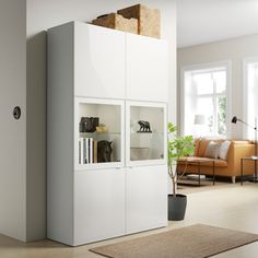 a white cabinet with glass doors in a living room