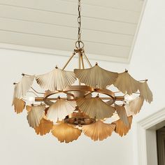 a chandelier hanging from the ceiling in a room with white walls and ceilings