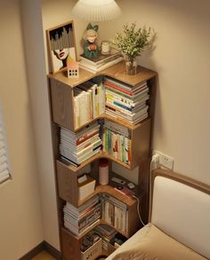 a bedroom with a bed and bookshelf next to a lamp on the wall