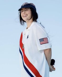 a woman wearing a polo shirt with an american flag on it