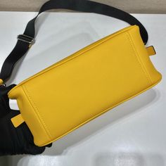 PRD Triangle Bag Yellow For Women, Women’s Bags 9.8in/25cm 1BB082_2BYA_F0377_V_NEO Rep 1:1 This soft bag reinvents in an innovative way the classic and sophisticated shape of the top-handle bag, transforming it into a versatile, sporty design. The accessory with double handle and detachable logo-print woven tape shoulder strap can be worn in different ways and is decorated with a modern interpretation of the lettering logo appearing as an embossed detail. Size: 25 x 14.5 x 11 cm /9.8 x 5.7 Tape Shoulder, Cm Logo, Prada Triangle, Louis Vuitton Shirt, Chanel Shirt, Triangle Bag, Soft Leather Bag, Soft Bag, Sporty Design