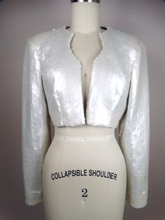 "This is a gorgeous couture vintage bolero jacket fully embellished with pearlescent ivory sequins. It's in perfect condition! Very well made! There are no closures, so measurements are taken with the front brought together. Bust - 36/38\" Shoulders - 16\" Sleeves - 24\" Length - 14\" Tag Size - 8 All of my items come from a smoke-free and pet-free home. If you have any questions, please don't hesitate to ask!" Embellished Fitted Party Outerwear, Fitted Embellished Outerwear For Party, Fitted Embellished Party Outerwear, Fitted Long Sleeve Cropped Jacket For Evening, Fitted Cropped Jacket With Long Sleeves For Evening, Fall Wedding Outerwear With Sequins, Glamorous Embellished Wedding Outerwear, Embellished Fitted Outerwear For Wedding, Long Sleeve Sequin Outerwear For Wedding